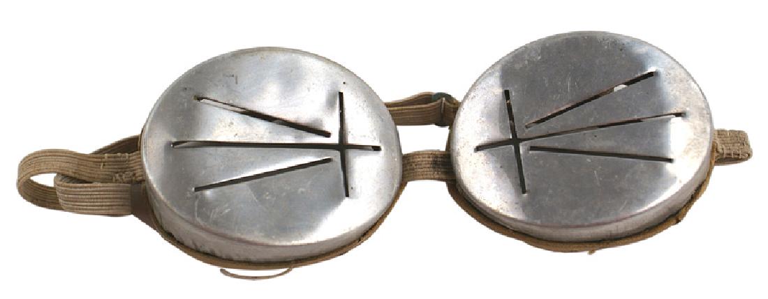 German WWII Mountain Troops goggles: N-014 German WWII Mountain Troops snow goggles. Metal eye covers with slits and elastic band. I