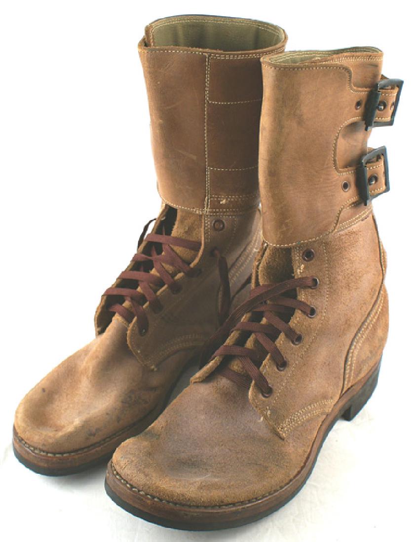 U.S. Army 1943 service combat boots: N-053 Army 1943 service/combat boots. Brown leather with a 4 1/2" cuff with two leather straps/buckles. Rubber soles (marked "EJ") and heels with horizontal raised lines. Size 10. About excellent. II+