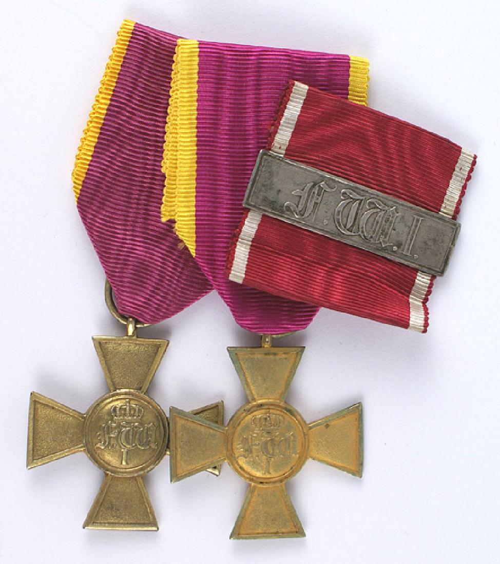 German Hessen-Kassel Long Service Crosses: B-024 Hessen-Kassel. Two Long Service Crosses for Officers, 25 Years 1849-1866. Unmarked, gilded crosses show light wear, age, and fading to finish. Both crosses are complete with suspension rings and