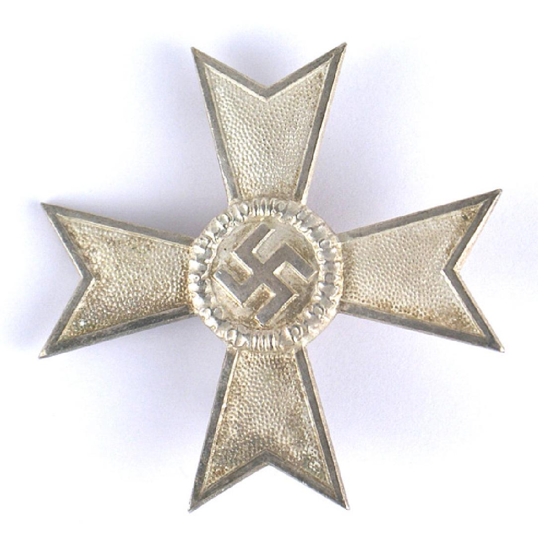 German WWII War Merit Cross KvK 1st Class: B-108 War Merit Cross (KvK) - 1st Class. Some patina on the silver Maltese Cross with a "polished" silver center swastika and borders. Wide pin marked "1" (Deschler & Sohn in Munich) II+