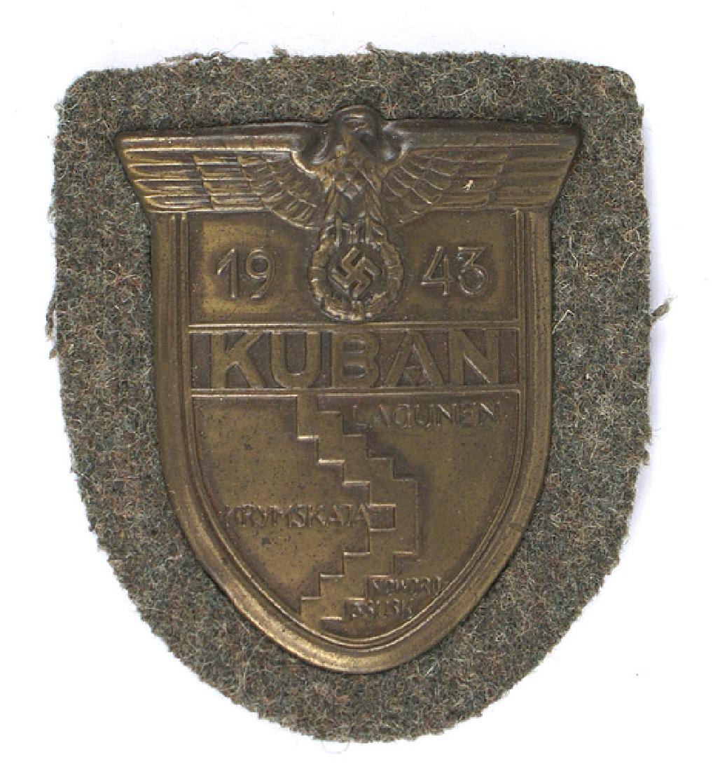 German WWII KUBAN Shield: B-149 "KUBAN" shield. Eagle/swastika and "1943" above area map. Mounted on Army feld-grau cloth with a backplate and paper backing. II+