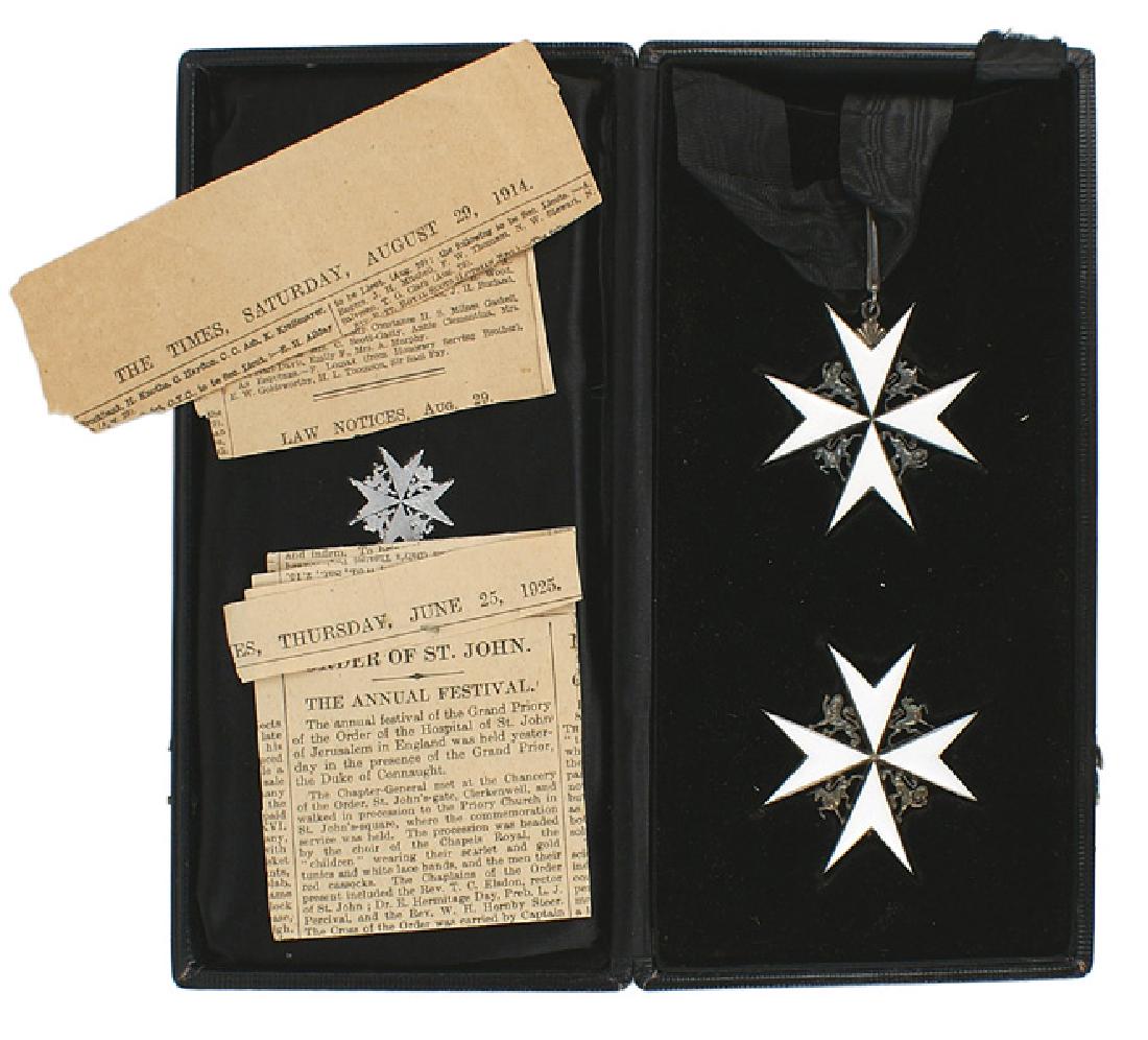 British Cased Order of St John Medal: B-285 Great Britain. Cased set - Order of St. John. White enameled Maltese Cross with age darkened silver lions and unicorns between the arms. With full neck ribbon and clasp. Also the pin-back badge 
