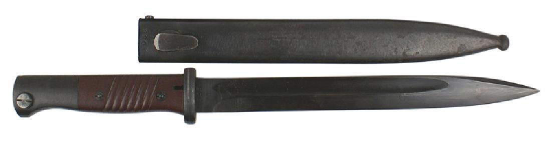German WWII K-98 Mauser bayonet: D-034 German WWII K-98 Mauser bayonet. Blued pommel and crossguard. Maroon bakelite grips. "Dimples" on the blued backstrap. 10" blade has 99% of the original blued finish. Numbered "4038vv". Also dat