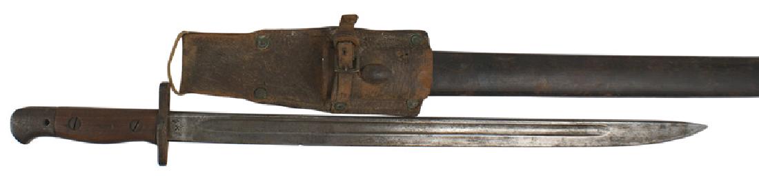 British pattern 1907 bayonet: D-049 British pattern 1907 bayonet. Age darkened steel pommel and crossguard. Smooth wood grips. 17 1/4" gray blade with dark patches. Marked with a crown over "1907", "11-6" and "WILKINSON". Reverse 