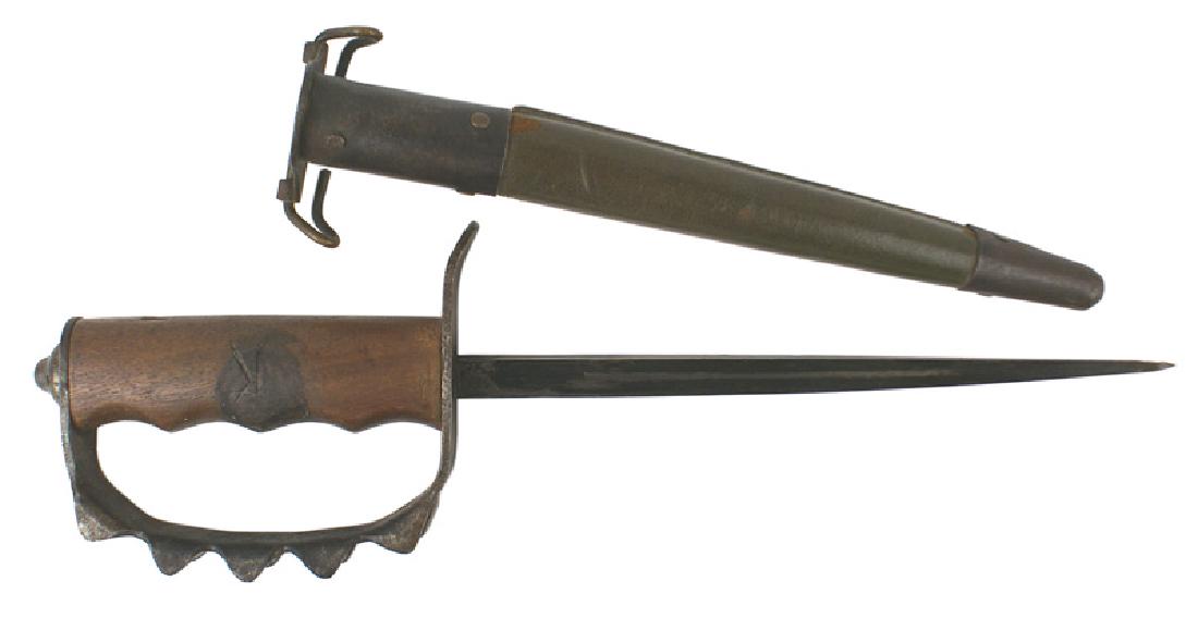 WWI M1918 trench knife: D-056 WWI M1918 trench knife. One-piece steel reverse "D" knuckle-bow with five "pyramid" type projections on each outer border. Dated 1917. Most of the blued finish is worn away. One-piece finger fit