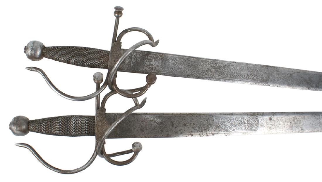 Spanish copies 16th Century Italian Broad swords: D-090 Pair Spanish copies of 16th Century Italian Broad swords. Well made with metal wire wrapped grips, ball pommel and large twisted branch guard. 33", 1 1/2" wide blade. Both sides etched with cupi