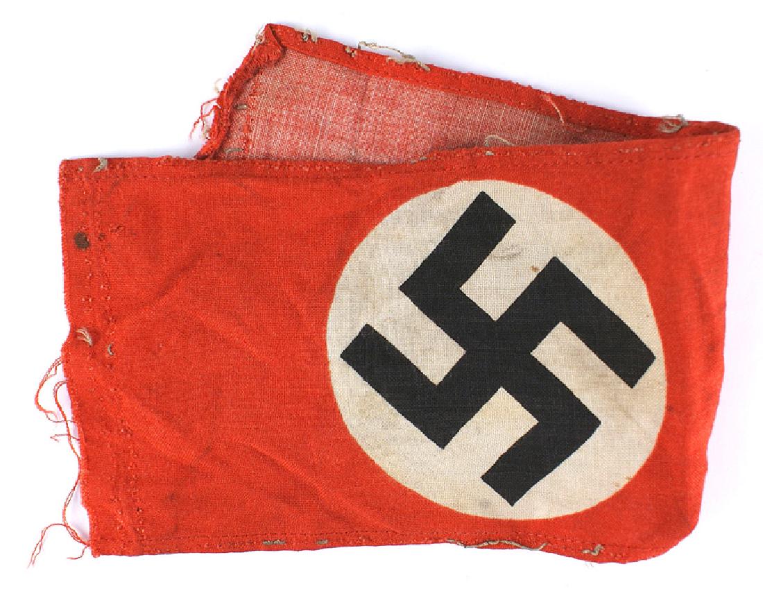 German WWII NSDAP armband: H-015 N.S.D.A.P. printed armband. Black tilted swastika on a white circle, on a red field. Separated at the stitching. Has thread remnants - indicates removal from a tunic. II