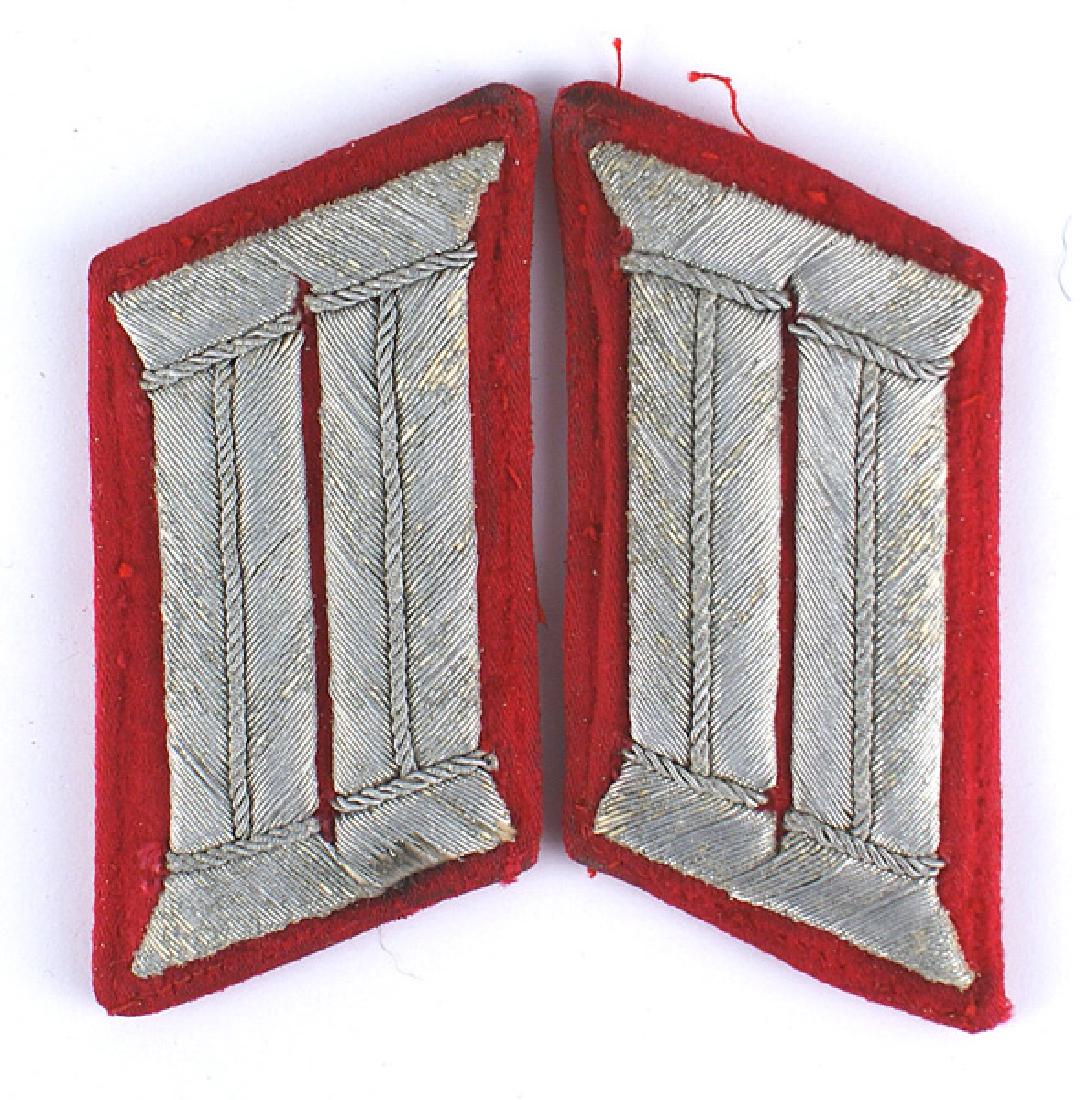 German WWII Army Artillery officer collar tabs: H-034 German WWII Army Artillery officer parade dress collar tabs. Silver bullion on red. Were removed from a tunic (thread remnants). Show some wear. About II