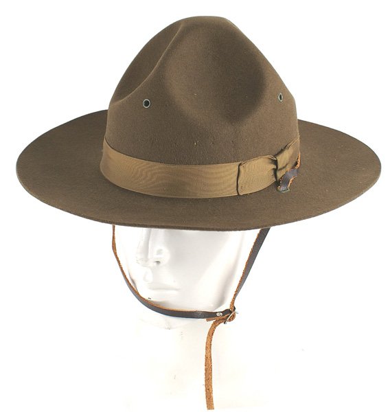 Well made reproduction Marine Corps DI hat: H-194 Well made reproduction Marine Corps DI hat. OD felt with a silk band. Black leather sweatband is embossed "HAT SERVICE, FIELD... 1944". Also a paper size tag ("7" over "56"). Leather chin strap.