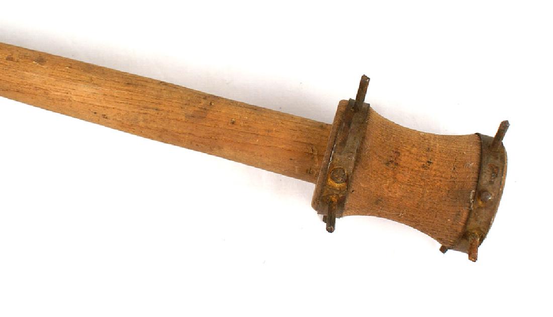 Austrian WWI trench club: N-004 Austrian WWI trench club. 19 3/4" tall tapered round wood handle-surmounted with a 4" "thread-spool" shaped head with an upper and lower steel band with each having four extended steel posts. II