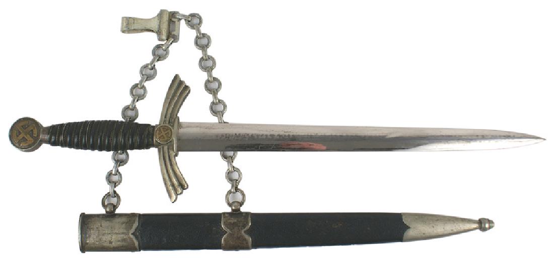 German WWII Luftwaffe 1st Model dagger: D-045 Luftwaffe 1st Model dress dagger. Darkened brass "sun wheel" swastika on pommel and center of turned-down winged crossguard. Wire wrapped leather grip. Bright 12 1/8" blade has dull areas where 
