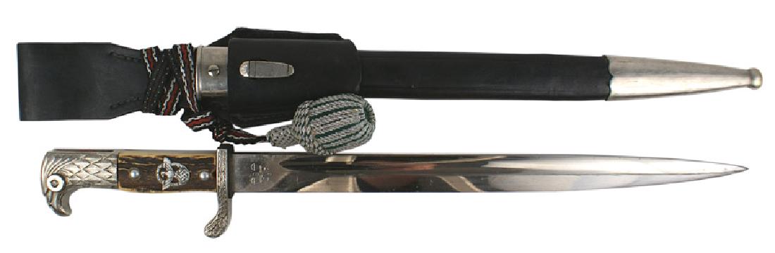 German WWII Police sidearm dagger: D-060 Police sidearm. Nickeled "feathered" eagle-head pommel is slotted (like a bayonet) with a red felt insert. Oak leaf decorated turned up short crossguard. Reverse stamped "S. Ar. II. 202". Police