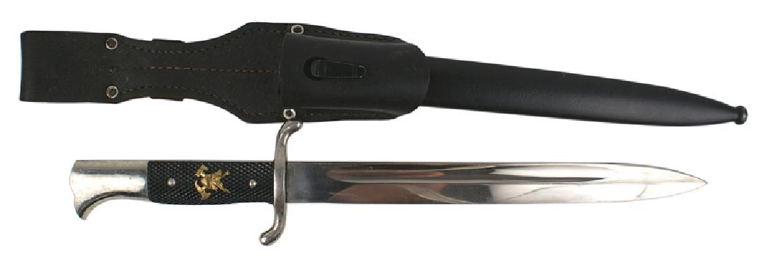 German WWII fire department sidearm dagger: D-064 German Third Reich period fire department sidearm. Nickeled "bird-head" pommel and "S" cross guard. Checkered black bakelite grips with a gilt fire insignia (helmet with crossed fire axes.) Clea