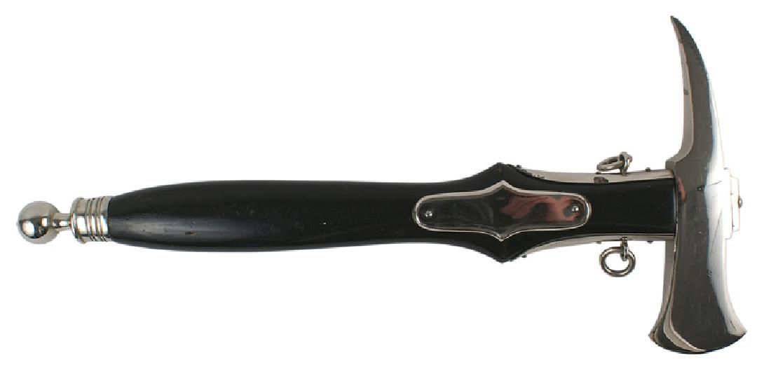 German WWII type Fire Department parade dress axe: D-065 German Third-Reich type Fire Department parade dress axe. "Tomahawk" style 7" x 2" nickeled side straps/rings, side plates and ball - top pommel cap. About excellent. I