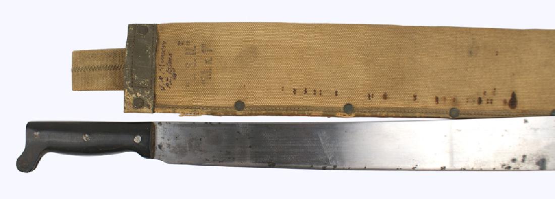 US Navy WWII MKI machete: D-096 US Navy WWII MKI machete. 26 1/4" curved wide blade with black spotting. Marked with a hammer/hand/crown logo and "USN MK-1" and "EGITMUS. COLLINS & CO-1942". Tan canvas scabbard marked "USN.-M.