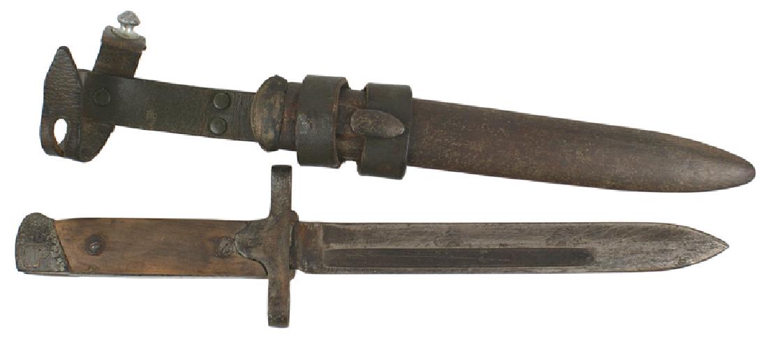 Italian M1938 Beretta sub-machine gun bayonet: D-108 Italian M1938 Beretta sub-machine gun bayonet. Ordinarily a folding blade but modified to stay in a rigid position. 7" blade is well worn, as is the steel scabbard, which has also been altered b