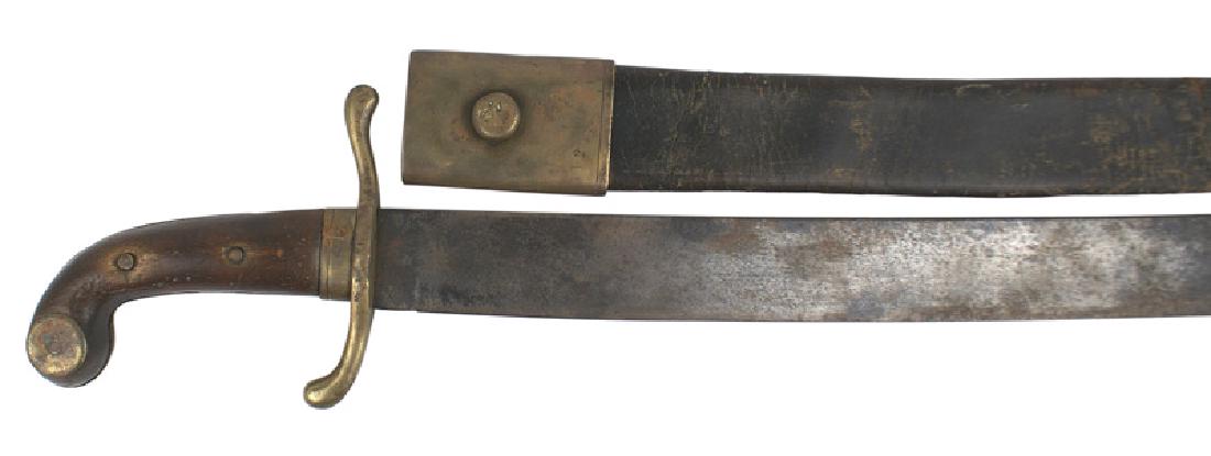 Spanish machete-type short sword: D-144 Spanish machete-type short sword. Brass "S"-type crossguard (marked "G. 92. C") and ferrule. Brass roundel affixed to the curved pommel of the wood grip (roundel missing on the reverse side). 1