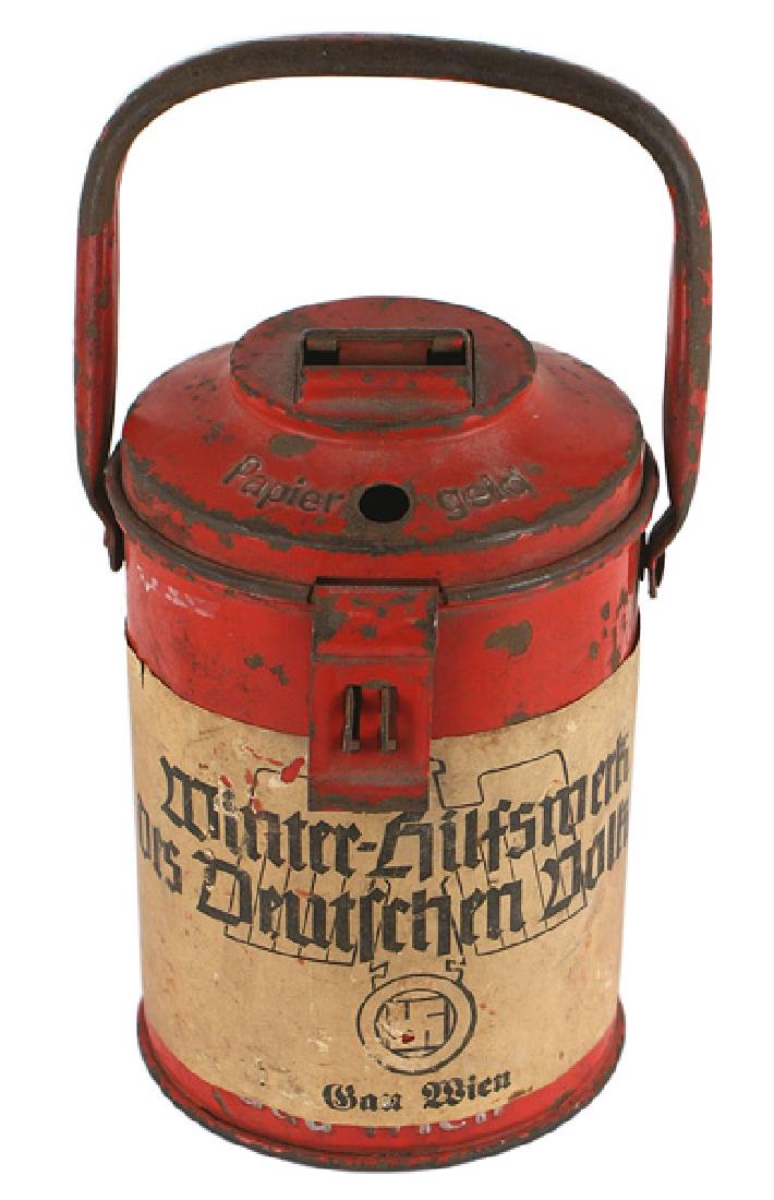 German WWII Winter Help collection can pennant: H-127 "Winter-Hilfe" collection can and pennant. Red 7" canister with handle. Paper label with large eagle/swastika, "Gau Wien" and "Welfare Work for the German People". Maker marked. II