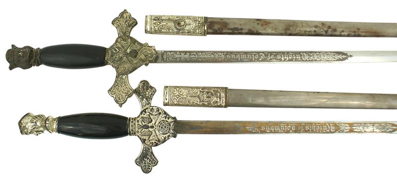 Lot of 2 Knights of Columbus dress swords: K-046 Lot of 2 Knights of Columbus dress swords. Silvered Columbus head pommel and crossguard bearing a large center emblem of a dove/cross/globe. Polished wood grip. 28" straight blade with a gilt pa