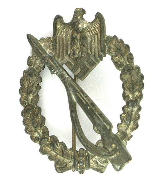 German WWII Infantry Assault Badge: B-133 Infantry Assault Badge - Silver. Rifle with fixed bayonet on an open wreath and eagle/swastika at the top. Solid type. Some traces of the original silver finish. II