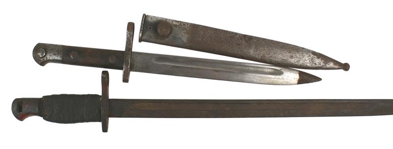 Lot of 2 bayonets US made British Unknown: D-068 Lot of 2 bayonets: (1) US made British M1914 bayonet. Rusted and darkened pommel (missing press stud) and crossguard/muzzle ring. Original grips are missing and tang has old tape wrapping. 16 7/