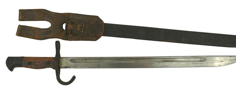 Japanese Ariska M1897 bayonet: D-087 Japanese Ariska M1897 bayonet. Darkened steel pommel and crossguard with a hooked quillon, Wood grip. 15 1/4" clean blade (no markings). Darkened steel scabbard shows several dents. Brown leathe