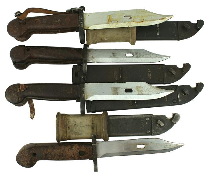 Soviet Russia lot of 4 bayonets: D-092 Soviet Russia. Lot of four "old pattern" Shtik Kalashnikova bayonets. Unfullered 5 7/8" bowie type blade with a serrated spine and elliptical hole near the tip (for attaching scabbard to use as 