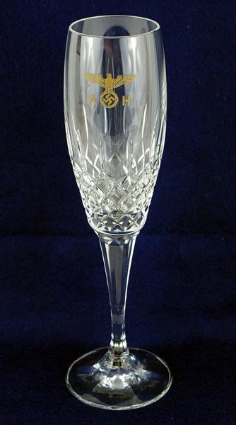 Adolf Hitler personal leaded crystal champagne glass: A-024 Adolf Hitler Leaded crystal champagne glass. Gilt political eagle/swastika with "AH" on the upper section of the 5 1/4" tall bowl. The lower section is a collar of "diamonds". 5" tapered stem on