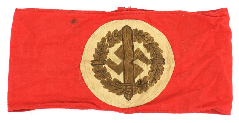 German WWII SA Sports armband: H-017 German WWII SA Sports armband. Bevo embroidered copper-gold swastika/broad sword/ oak leaf wreath on a white circle-sewn on a red band. Paper "RZM" tag. About II