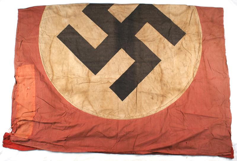 German WWII NSDAP flag: H-075 Third-Reich N.S.D.A.P. flag. Printed black tilted swastika on a white circle - on a red field. Overall 56" x 82". Aged, weathered and soiled. III