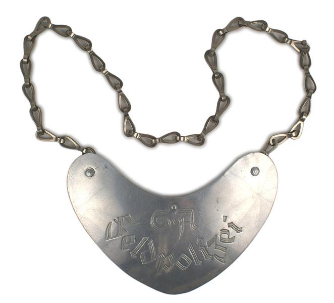 German WWII SA Field Police gorget: H-129 German WWII SA Field Police gorget. 3 1/4" x 6 1/2" aluminum crescent-shaped with gothic type engraving "SA Feldpolizei". Reverse has a tunic hook at the center and an unusual metal neck chain w