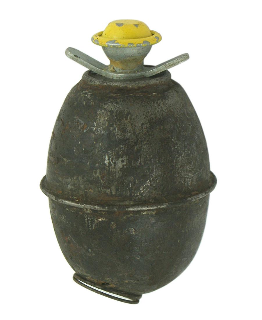 German WWII egg shaped grenade: M-021 German WWII egg shaped grenade. Extended ridge around center. Finial with ears at the top. Base has a round ring. Shows age and wear. II-