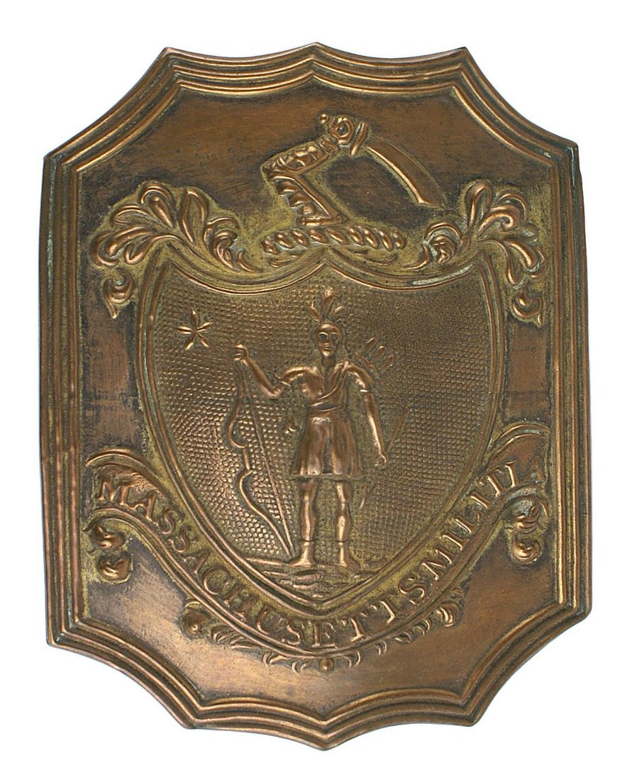 US Massachussets Infantry shako hat plate: K-049 U.S. Massachussets Infantry shako/hat plate. Aged patina copper 4 3/8" x 3 1/4". Scalloped top and bottom with a relief shield bearing an upraised arm with a sword and Indian and "MASSACHUSSETS 