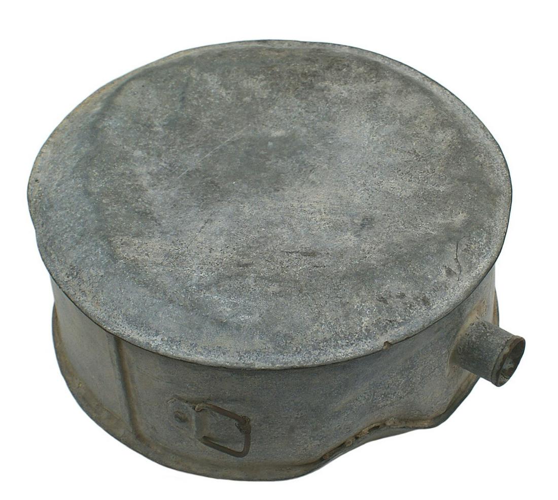 Large Civil War Confederate tin canteen: K-058 Large Confederate tin canteen. 9" diameter and 3 1/2" wider spout at top. One of the square swivel swing loops is still attached, one is missing. A name and writing on the side of the canteen ar
