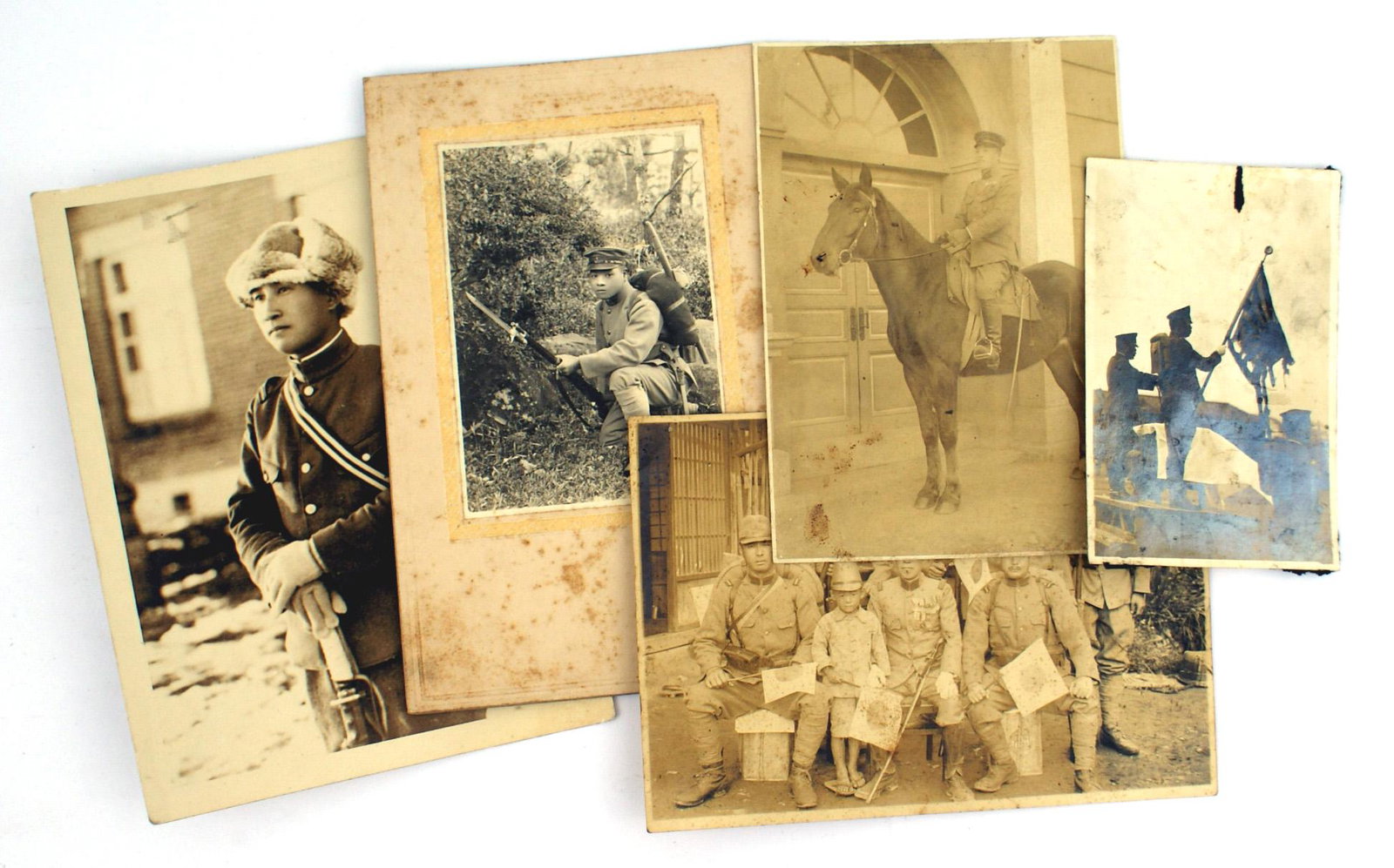 Lot of 5 Japanese WWII photos Rising Sun flag: L-023 Lot of 5 Japanese WWII photos. Including: standard bearer holding a battle damaged "Rising Sun" flag (4 1/4" x 2 11/16"), mounted cavalryman (5 3/8" x 3 3/4"), six soldiers and young boy holding