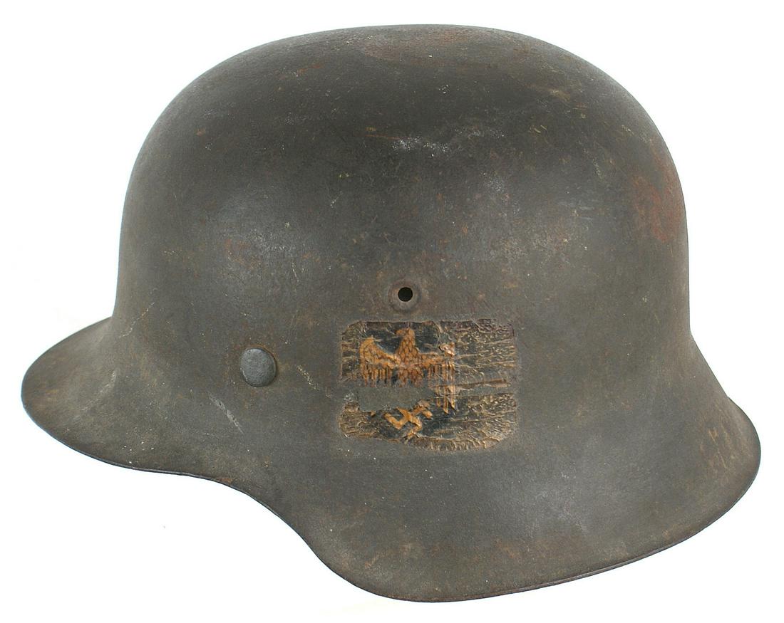 German Navy Coastal Artillery M1942 helmet: E-031 German Navy Coastal Artillery M1942 single decal helmet. 75% original dark green finish. 50% eagle decal was covered with a clear plastic panel sometime ago and has dried and stiffened. Missing 