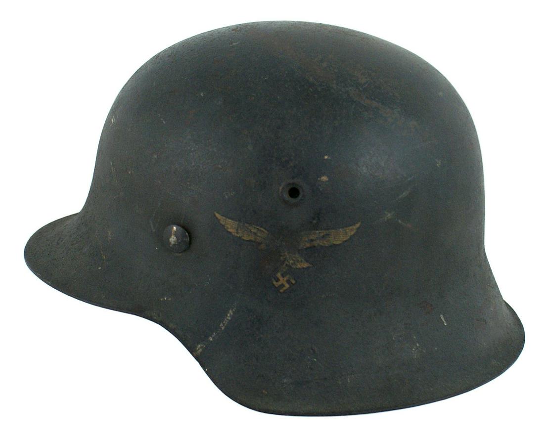 German Luftwaffe M1942 single decal helmet: E-036 German Luftwaffe M1942 single decal helmet. 90% original "rough" blue-gray finish. 75% eagle decal. Original leather chinstrap, dated "1941". Liner band is missing the leather drawstring liner. 