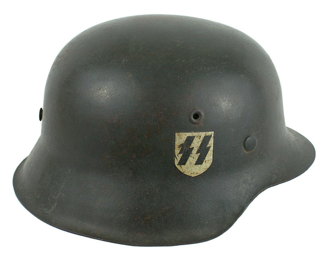 German M1942 Waffen SS combat helmet: E-038 German M1942 Waffen-SS combat helmet. Usual wear to the feldgrau paint finish. Second pattern SS runes decal, shows age dimples. 95% intact. Inside dome has the acceptance stamp. Rear skirt is s