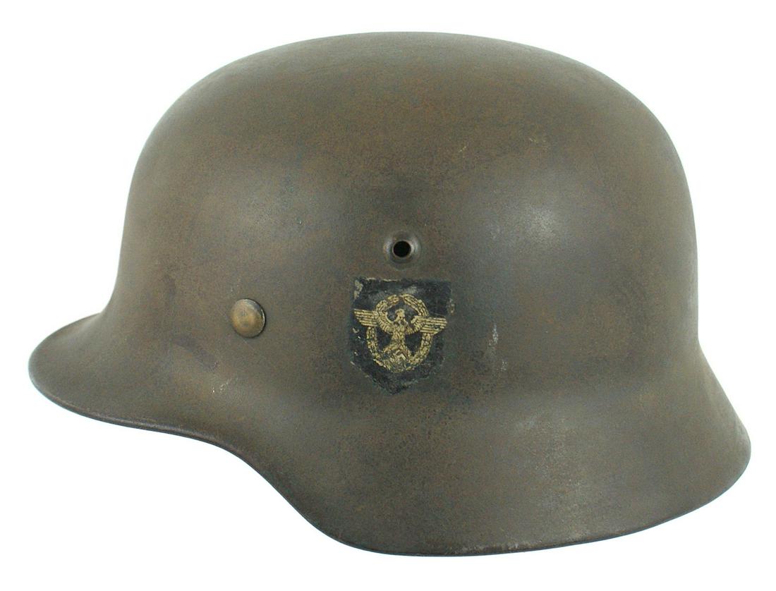 German Police M1940 double-decal combat helmet: E-040 German Police M1940 double-decal combat helmet. National colors shield shows some scratches but would rate 85%. The swastika shield has some wear and small chips - would rate 70%. Original green