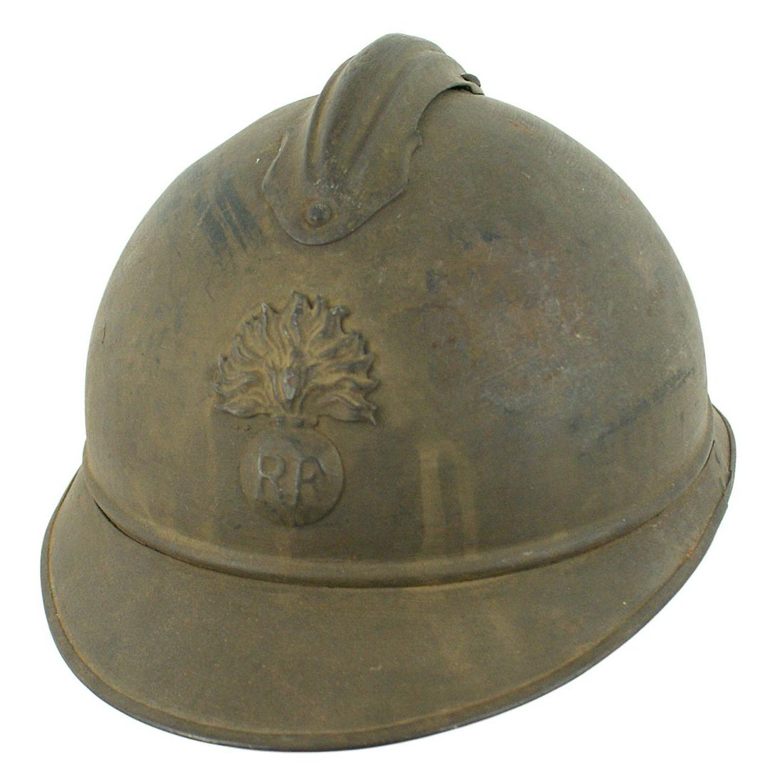French WWI poilu helmet: E-055 French WWI "poilu" helmet. Adrian type with a comb. "RF"/flaming grenade insignia on front. 60% O.D. finish. Leather drawstring liner and chinstrap. II
