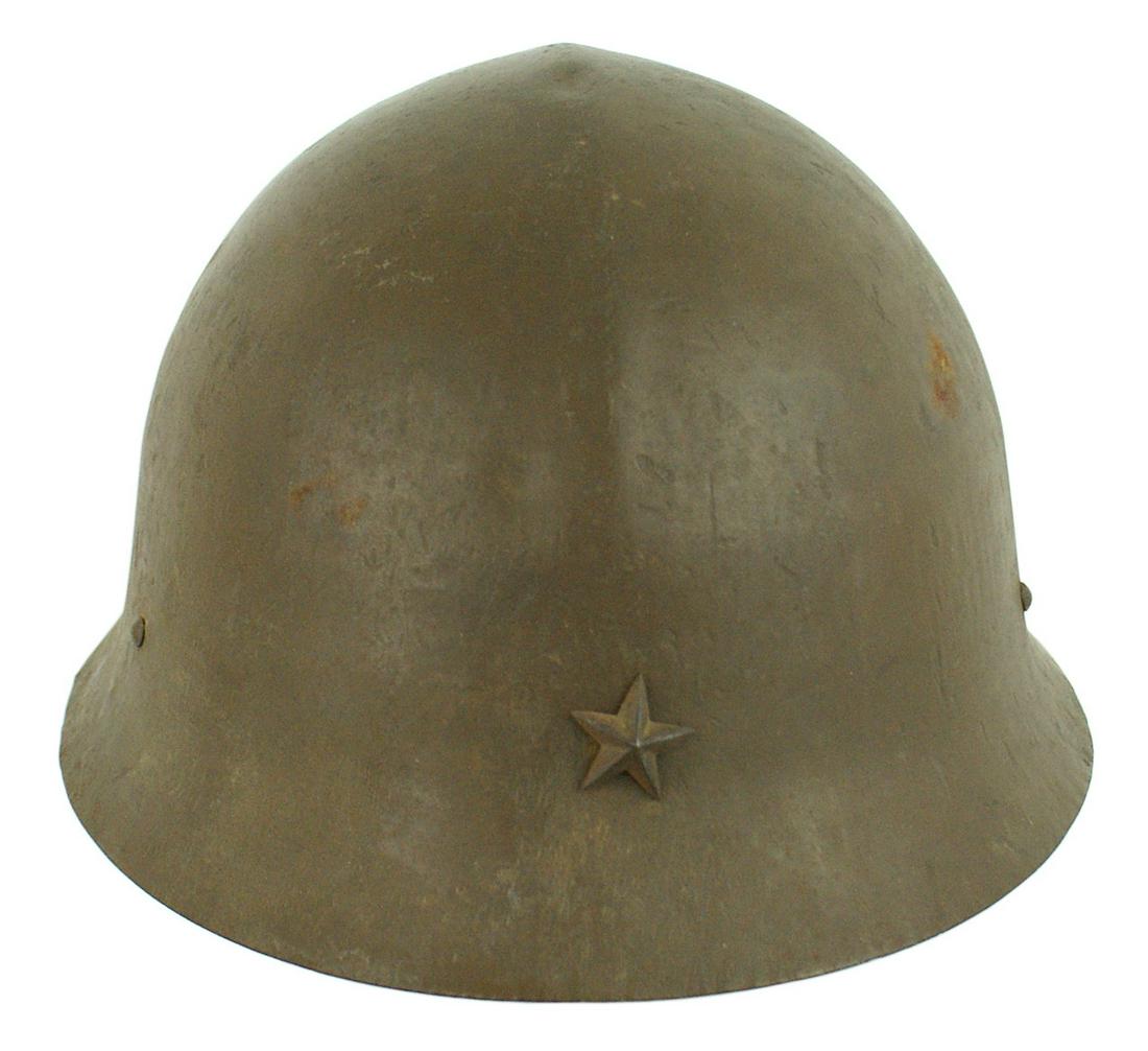 Japanese WWII Army helmet: E-065 Japanese WWII Army helmet with a subtle ridge down center. Age darkened star. Two liner band rivets, and three small domed rivets hold the "D" rings for the chin cords (missing). Burlap type ban