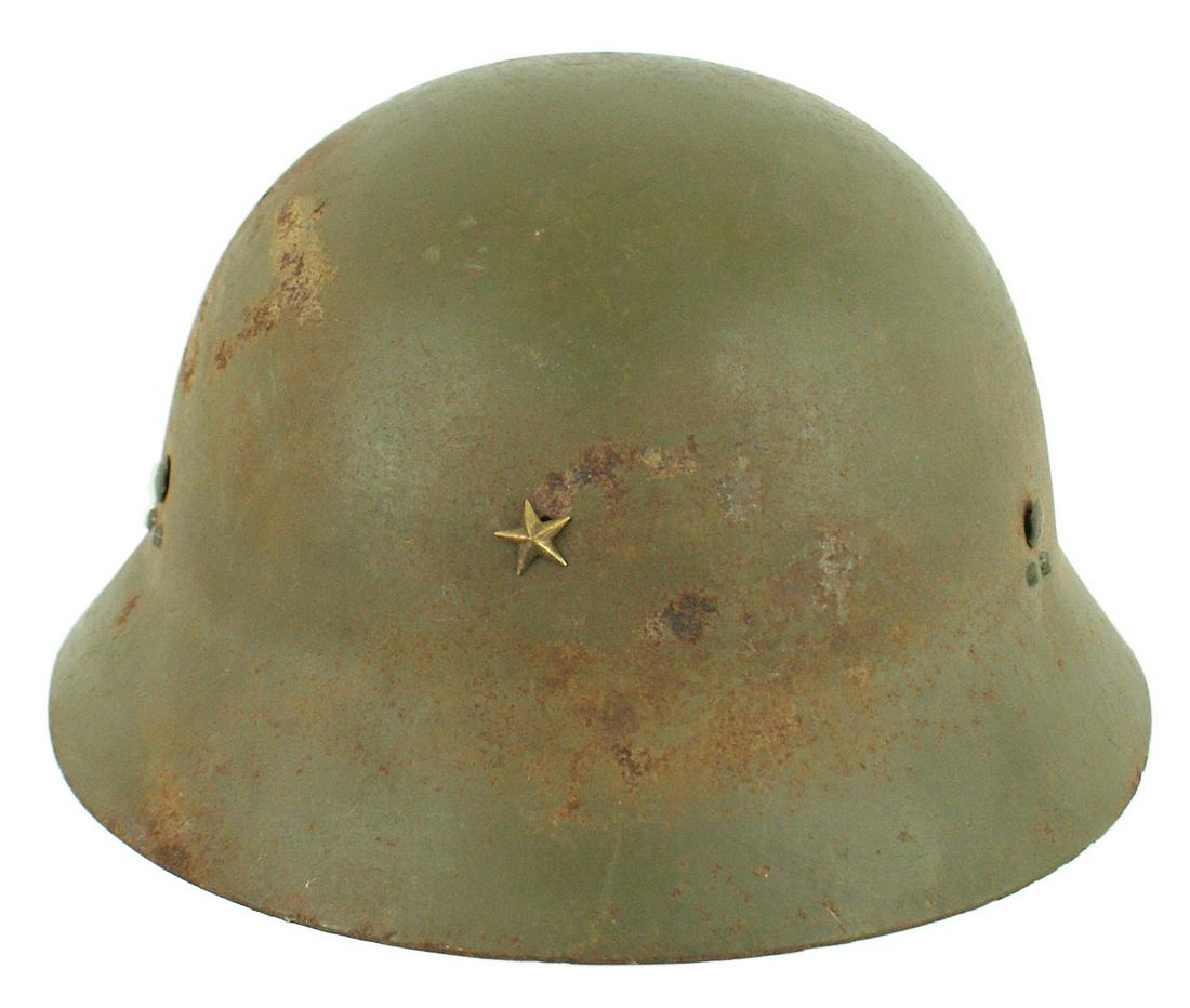 Japanese WWII O.D. helmet: E-067 Japanese WWII O.D. helmet with an extended brim circling the skull. Three sets of three rivets each, consisting of one large and two smaller. The larger hold the liner band with a well marked bu