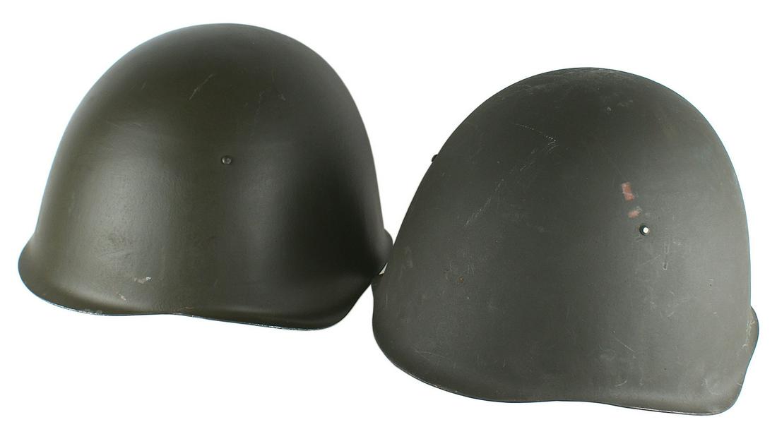 Lot of 2 Soviet post WWII helmets: E-074 Lot of 2 Soviet post WWII helmets. O.D. finish. Web chinstrap and leather eight-tongue leather. One of the helmet liner stampings ("KJ-SP...") indicates a Polish issue. About excellent. I