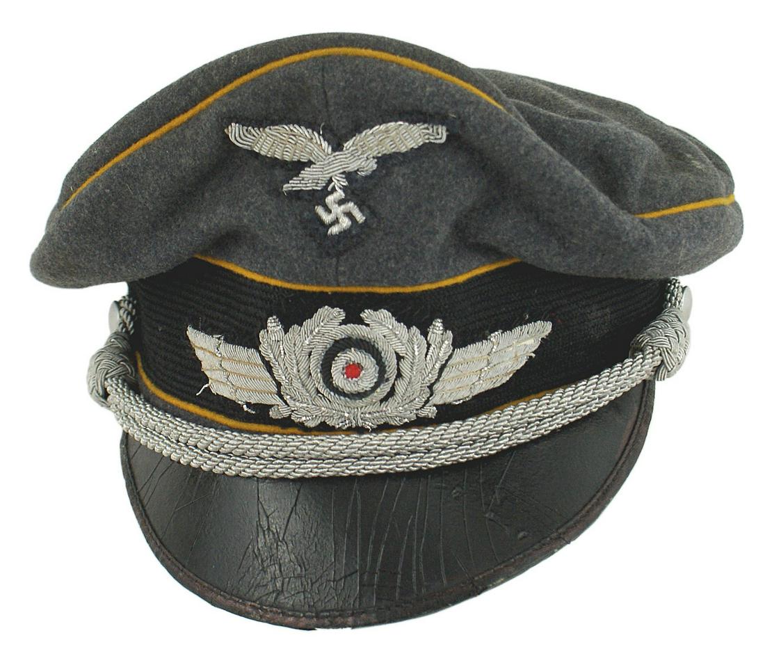 German WWII Luftwaffe Flight peaked cap: E-088 German WWII Luftwaffe EM/NCO Flight peaked cap, filed converted to an officer's "crusher" cap. Blue - gray wool body with a black mohair band and age toned yellow - gold piping. High peak and pu
