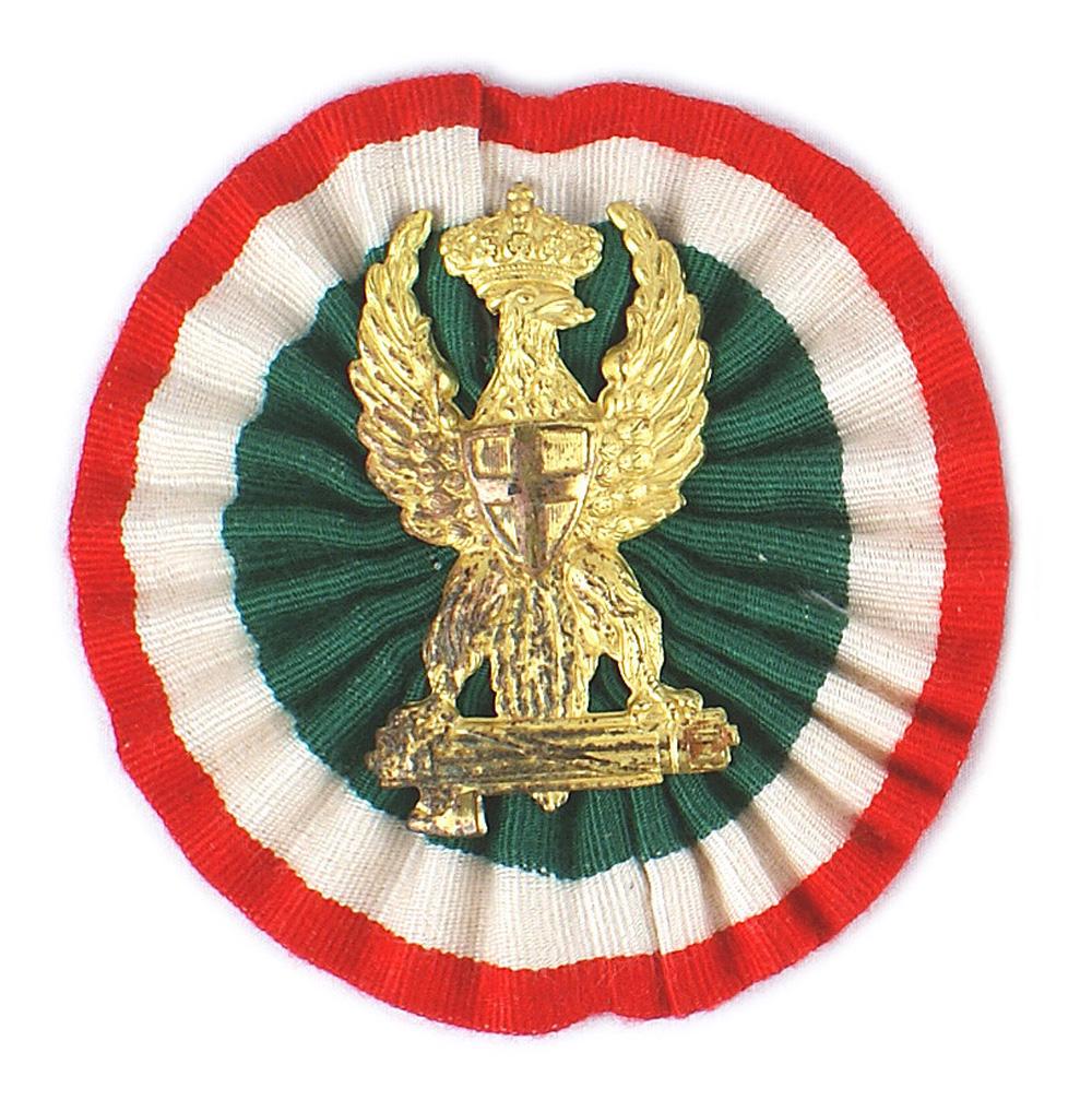 Italian Fascist Army pith helmet insignia: E-116 Italian Fascist Army Officer's pith helmet insignia. Gilt metal crowned eagle/shield of Savoy/fasces - on the center of a 3 4/8" diameter "wrinkled" Italian ribbon rosette. I