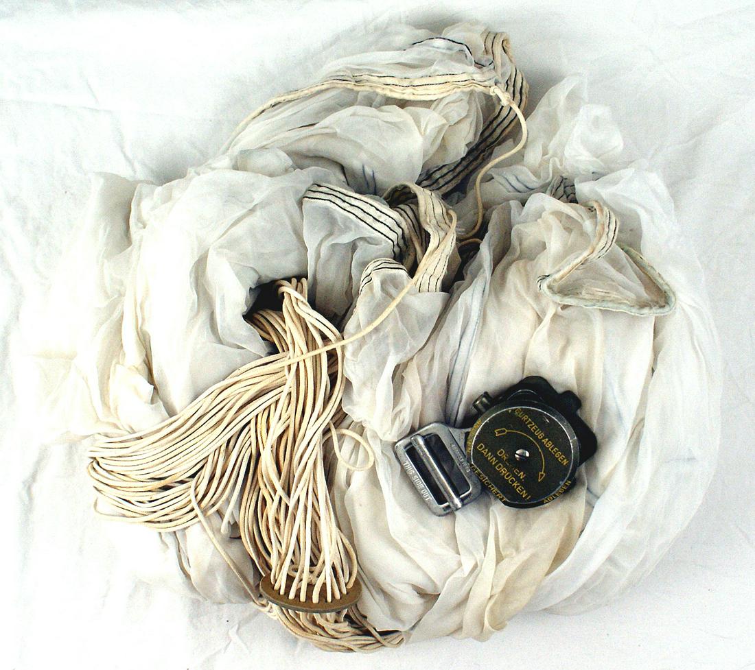 German WWII Luftwaffe parachute and buckle: N-017 German WWII Luftwaffe parachute and post - war parachute quick release buckle. Supply type parachute with all cords and disc spacer. II