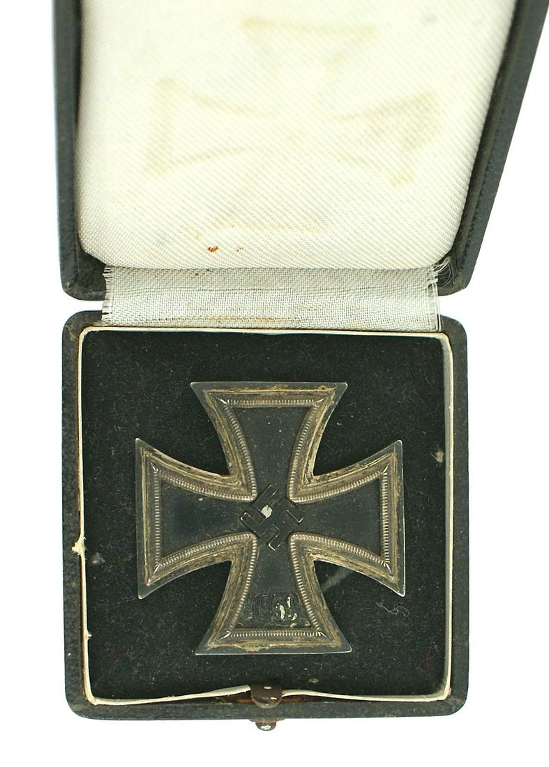 German WWII 1939 1st Class Iron Cross: B-037 German WWII 1939 Iron Cross 1st Class. Black center with a relief swastika and "1939". Silver frame has a nice patina. Silvered "coke - bottle" pin on reverse is marked "L/58" (Arthur Jokel & Co