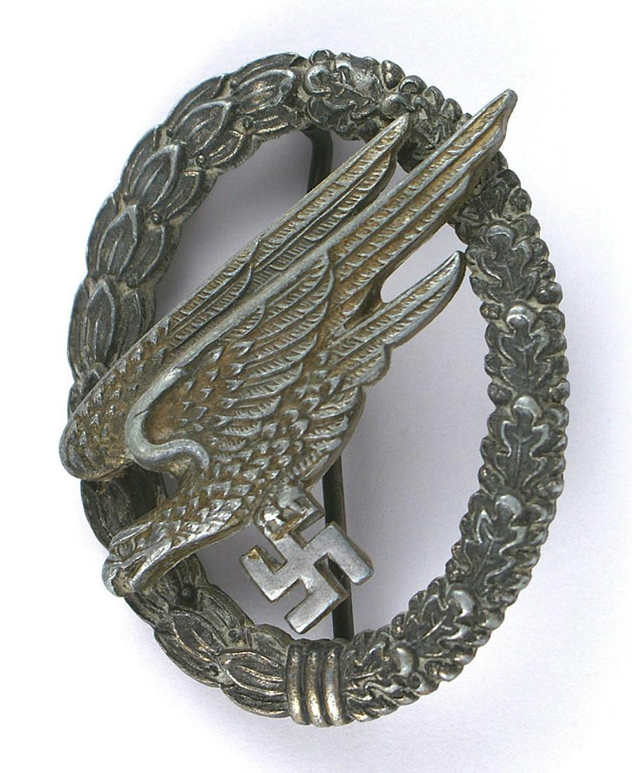 German WWII Parachutist Badge: B-064 German WWII Parachutist's Badge - heavy zinc construction. Gilt finish worn on swastika. Darkened wreath retains some silver patina. Reverse marked "G.H. OSANG - DRESDEN" About II