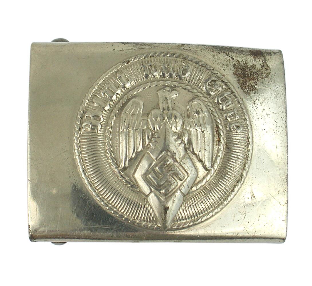 German WWII Hitler Youth belt buckle: H-015 German WWII Hitler Youth belt buckle. Relief eagle/diamond/swastika and "Blut und Ehre". Nickel finish. Marked "RZM" and one small area of wear to the nickeled finish. II