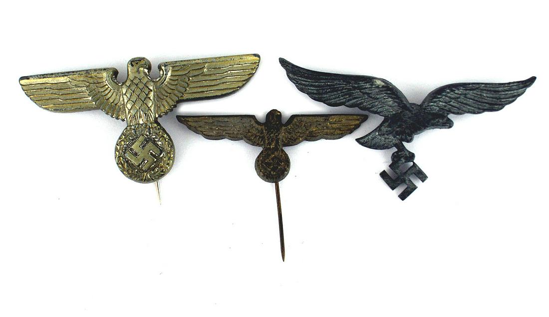Lot of 3 German WWII hat eagles: E-122 Lot of 3 Third-Reich hat eagles: (1) Luftwaffe peaked cap eagle/swastika. (2) Navy darkened eagle/swastika on stickpin for the "Donald Duck" cap. (3) Political type silver long-winged eagle for 